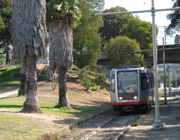 Picture of J Church train in Mission Dolores Park right of way